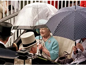 Brooch Prints: The Queen Mother protects herself from the rain as she arrives in a horse-drawn carriage