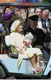 The Queen Mother rides in her buggy outside Clarence House as Britain