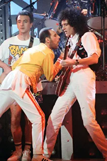 Queen rock group performing. Singer Freddie Mercury with guitarist Brian May
