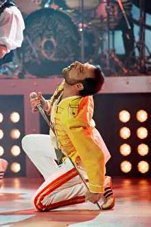Queen rock group performing. Singer Freddie Mercury on stage