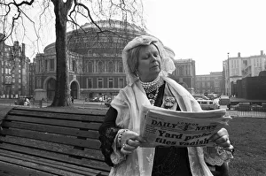 A Queen Victoria lookalike sitting on a park bench in Kensington Gardens close Royal