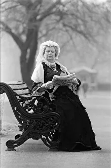 00967 Prints: A Queen Victoria lookalike sitting on a park bench in Kensington Gardens close Royal