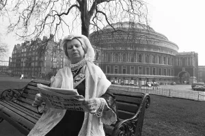 00967 Prints: A Queen Victoria lookalike sitting on a park bench in Kensington Gardens close Royal