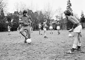 Teaching Prints: Queens Park Rangers footballer Don Masson coaching children to play football at the Our
