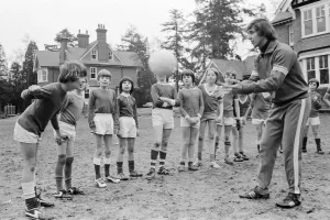 Queens Park Rangers footballer Don Masson coaching children to play football at the Our