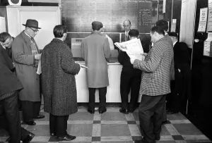 00170 Prints: A queue of punters waiting to place bets in the shop before a race March 1963