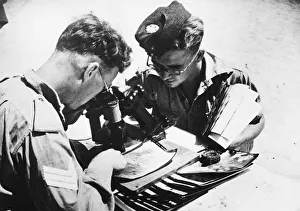 01472 Prints: An R. A. F. Intelligence Officer scrutinises aerial photographs in the Western Desert