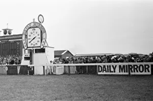 Clock Prints: Racegoers gather at the finishing post during the Andy Capp Handicapp race meeting
