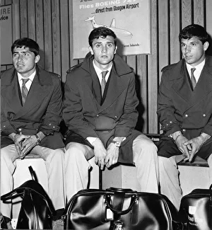Three People Prints: Racing Club of Argentina players waiting for their luggage at the airport as they land in