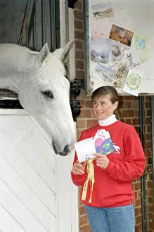 Images Dated 3rd July 2012: Racing Legend Desert Orchid being read his fan mail by stable girl Janice Coyle