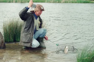 00111 Prints: Radio Disc Jockey Chris Tarrant enjoying a spot of fishing in his spare time