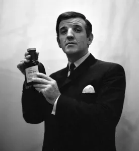 00198 Prints: Radio DJ Alan Freeman holding a bottle of Mersey water February 1964