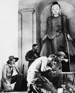Radio Telephonists at work beneath a gigantic idol in whose Temple a command post has