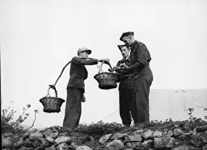 The RAF in the Azores, Portugal. Buying oranges from a local vendor. February 24, 1944