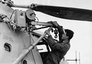 Air Force Prints: RAF ground crew member T Walton seen here checks the winch on a RAF Bristol Sycamore HR13