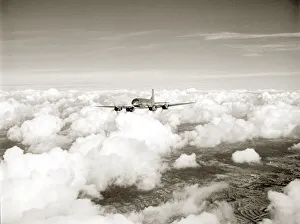 Aeroplanes Prints: RAF Hastings aircraft flies through cloud cover far above the landscape below. Circa 1950