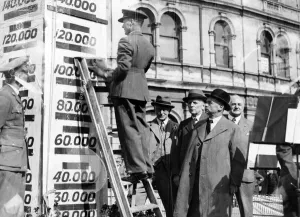 RAF officer raises the indicator of the Wings for Victory target at Penarth, Wales