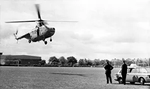 00367 Prints: A RAF Westland Whirlwind search and rescue helicopter lands on a sportsfield next to two
