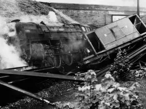 A railway guard leaped from his van seconds before it was hurled off the line by a steam