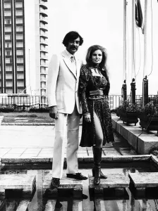 Raquel Welch and Terry Scott-stars of the film beloved stand together on a roof top