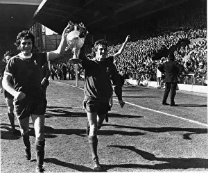 Ray Clemence and Larry Lloyd of Liverpool parade the League Championship trophy following