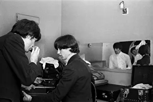 Ray Davies and Dave Davies of The Kinks pop group rehearsing in their dressing room