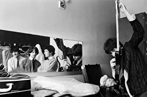 Ray Davies (right) of The Kinks pop group rehearsing in their dressing room before a