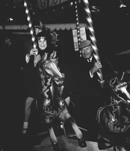 Fairground Rides Prints: Raymond Francis with his daughters Francis and Caroline on the merry-go-round
