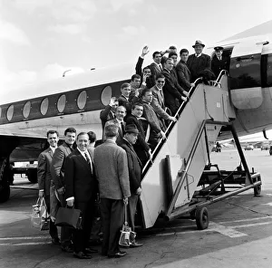 Real Madrid football team at London Airport waving goodbye as they board a plane for