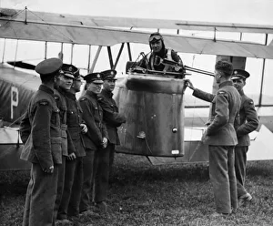 A rear gunner of 51 Squadron poses in a rear turret of a Vickers Virginia X with members