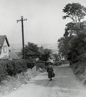 Country Lane Prints: Rear view of a woman walking down a rural country lane near West Bromwich in the West