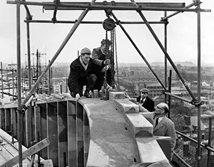 Rebuilding Coventry. Men at work, attaching the keystone to complete the masonry
