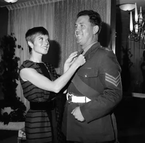 A reception for the film Oliver! Shani Wallis who plays Nancy adjusting the tie of a man