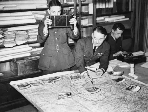 Reconnaissance Prints: Reconnaissance photographs being assessed at an R. A. F. headquarters
