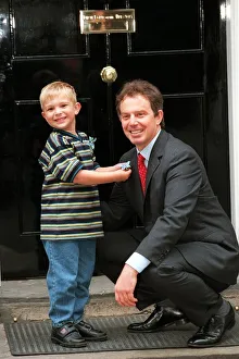 Cancer Prints: Recovered cancer patient Alexander Taylor (4 ) from Staffordshire presents Prime Minister