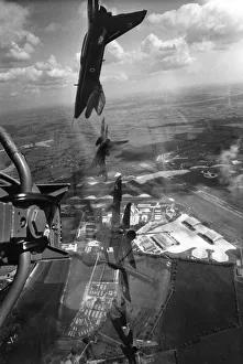Aerobatics Prints: A Red Arrows display Gnat trainers flying in formation over their base at Chivenor