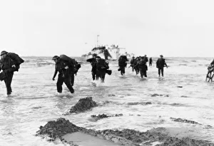 01220 Prints: Red Cross personnel wade ashore from landing craft on Queen sector