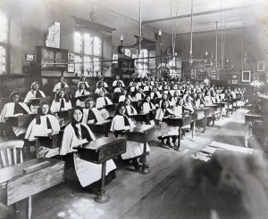 Red Maids in their distinctive outfits in the old school in Denmark Street Bristol Circa