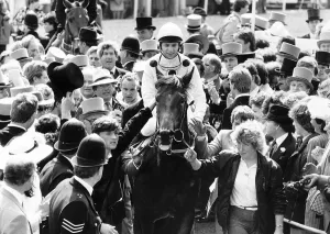Reference Point with jockey Steve Cauthen being escorted to the winners enclosure after