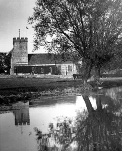 Country Lane Prints: The reflection of a church in the neighbouring lake in a Kent village Circa 1935