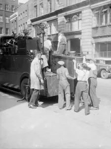 Carrying Prints: Removal men seen here packing up office furniture from a City of London business which