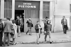 00067 Prints: Renault factory workers leaving at the end of a shift through a door marked