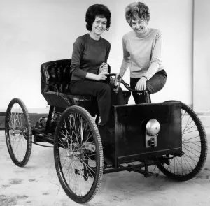 Vintage Prints: Replica Henry Ford Quadricycle being tried out by office girls Joan Milner