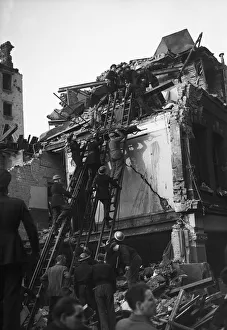 Rescue Prints: Rescue workers search through the rubble and wreckage of Warwick Court, Holborn