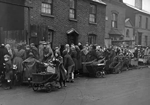 Queue Prints: Residents of Birmingham queue with their prams at the Coal Merchants in Green Lane