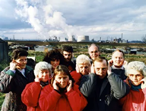 Residents of Lazanby cover their ears as the noise from the Enron site becomes unbearable