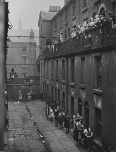 Poverty Prints: Residents of a Liverpool terrace pose for the Daily Herald photographer. 2nd March, 1933