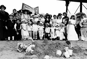 Images Dated 18th July 1988: Residents of Saltburn watch as Janet Williamson, 19, is buried in the sand during