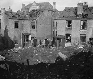 Residents of Vincent Street Balsall Heath, Birmingham, examine a bomb crater following an