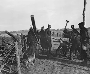 Barbed Wire Prints: Retreating Belgian and Royal Marines errecting a barbed wire entanglement across the road